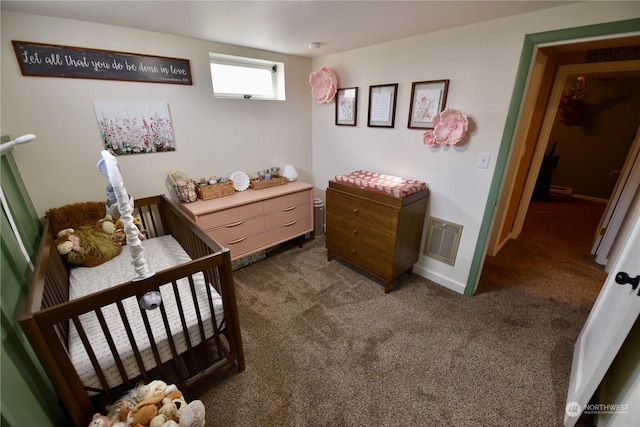 carpeted bedroom featuring a baseboard heating unit