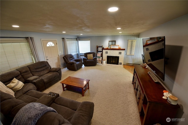 carpeted living room with a brick fireplace