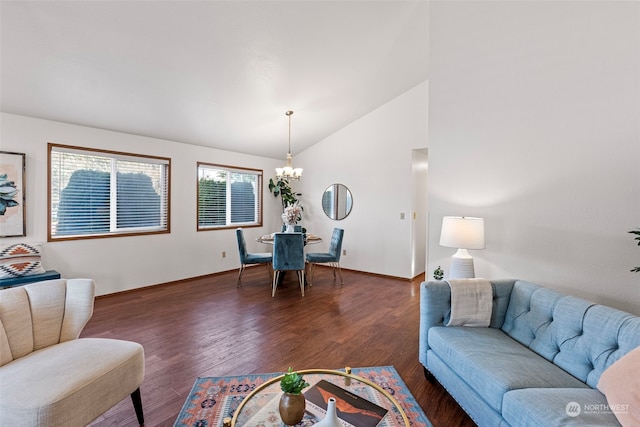 living room featuring an inviting chandelier, vaulted ceiling, and dark hardwood / wood-style floors