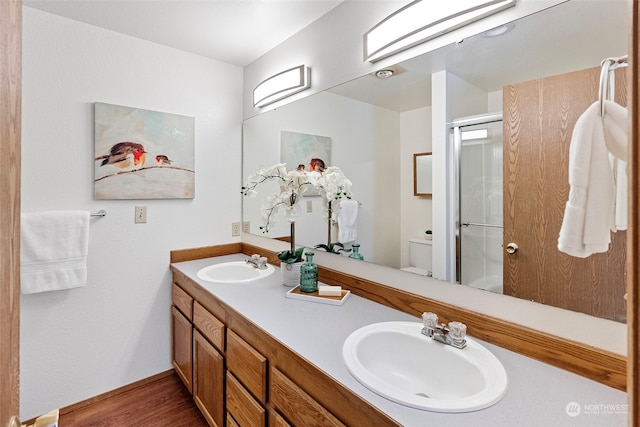 bathroom featuring walk in shower, vanity, and toilet