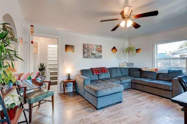 living room featuring ceiling fan and light hardwood / wood-style flooring