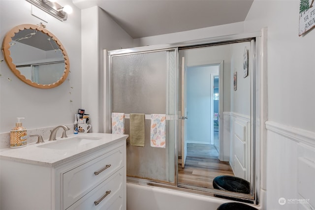 bathroom featuring vanity and bath / shower combo with glass door