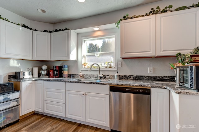 kitchen featuring white cabinetry, sink, light hardwood / wood-style floors, and dishwasher