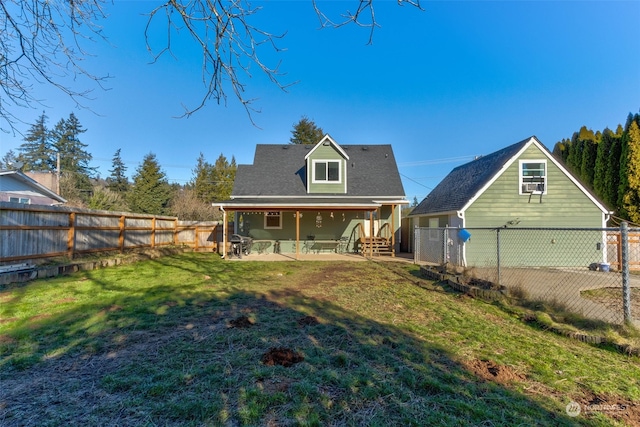 rear view of property featuring a yard and a patio area