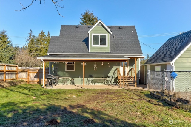 rear view of property featuring a yard and a patio area