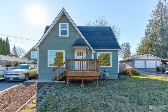 view of front of home featuring a carport, a garage, central AC unit, an outbuilding, and a front lawn