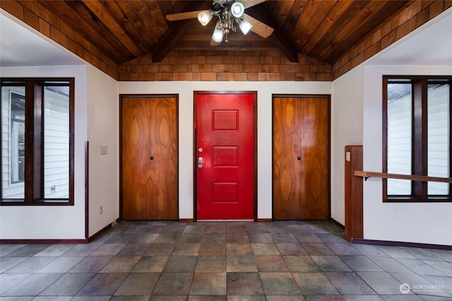 foyer entrance with wood ceiling, lofted ceiling with beams, and ceiling fan