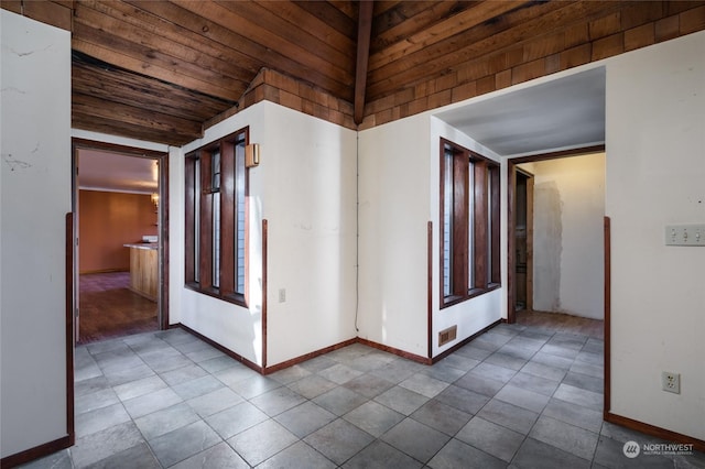 hall with lofted ceiling and wooden ceiling