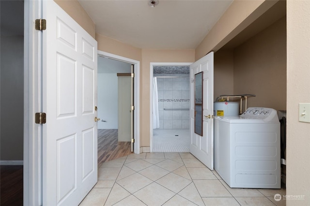 laundry area with washer / dryer and light tile patterned floors