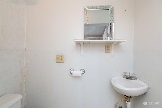 bathroom featuring sink and toilet