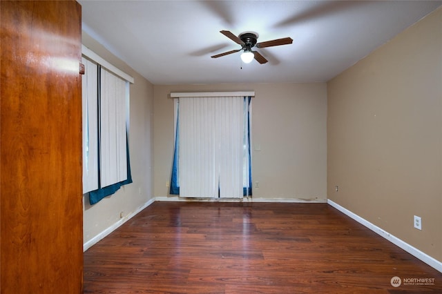 spare room featuring dark hardwood / wood-style flooring and ceiling fan