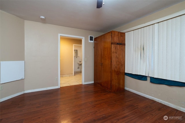 unfurnished room with ceiling fan and dark hardwood / wood-style flooring