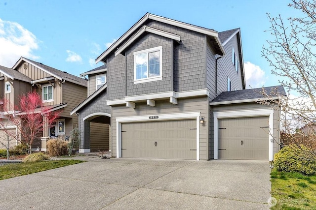 craftsman house featuring an attached garage and driveway