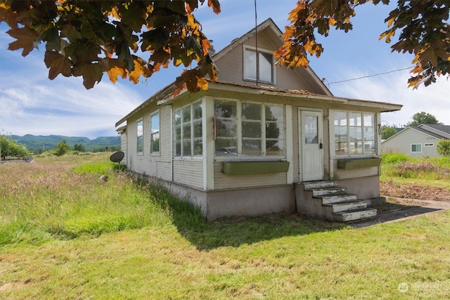 view of side of home with a lawn