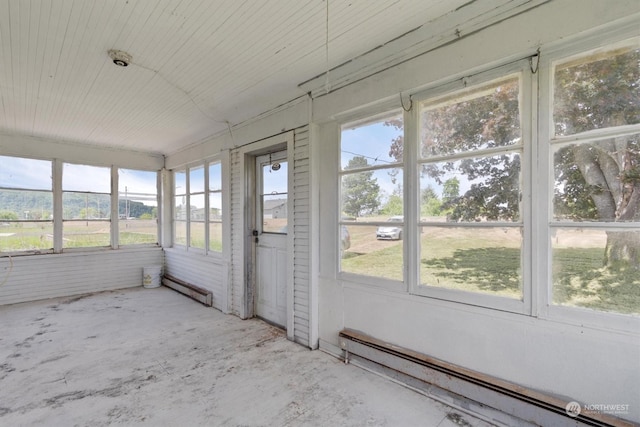 unfurnished sunroom with a baseboard radiator and a wealth of natural light