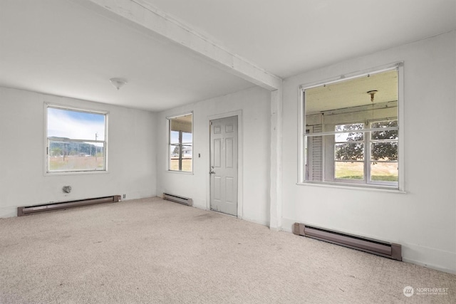 unfurnished room with a baseboard heating unit, beam ceiling, and carpet flooring