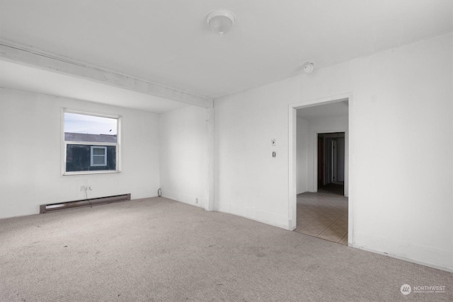 unfurnished room featuring carpet flooring and a baseboard heating unit