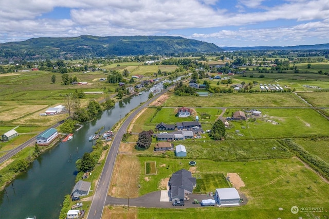 birds eye view of property with a water and mountain view and a rural view