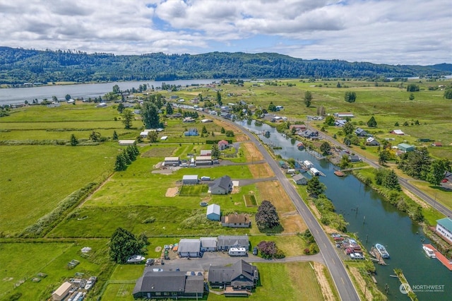 aerial view featuring a water and mountain view and a rural view