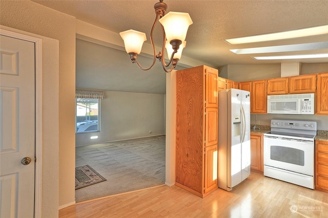 kitchen with lofted ceiling, a chandelier, hanging light fixtures, white appliances, and light hardwood / wood-style flooring