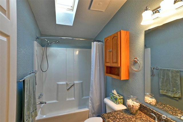 full bathroom with a skylight, vanity, shower / bath combo with shower curtain, and toilet