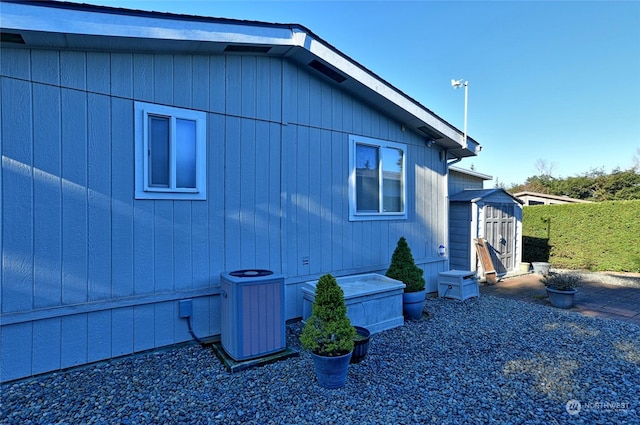 view of property exterior featuring a shed and central air condition unit