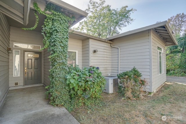 doorway to property featuring cooling unit