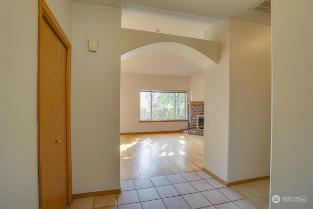 hall featuring light tile patterned floors