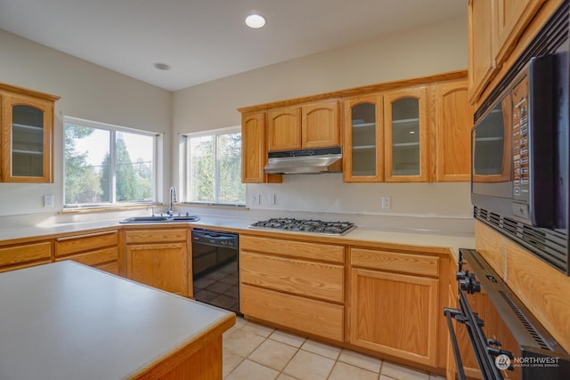 kitchen with sink, light tile patterned floors, and black appliances