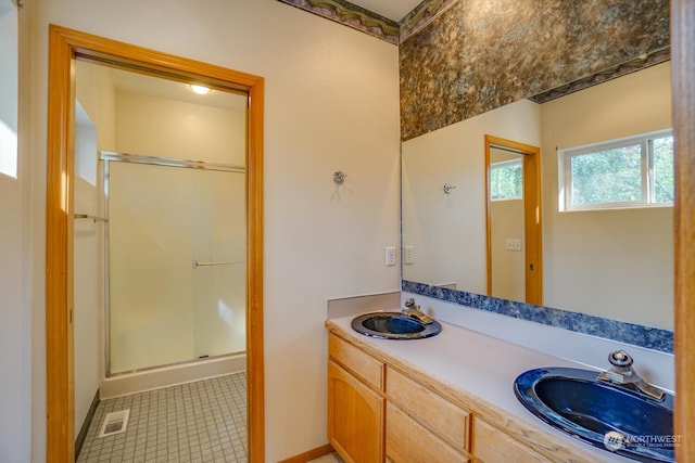 bathroom with tile patterned flooring, vanity, and an enclosed shower