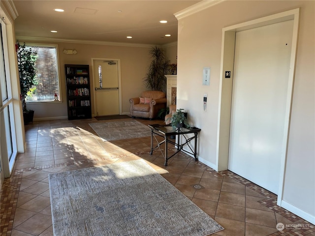 hall featuring crown molding, elevator, and dark tile patterned floors