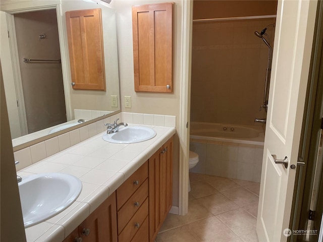 full bathroom with tile patterned floors, toilet, tiled shower / bath combo, and vanity