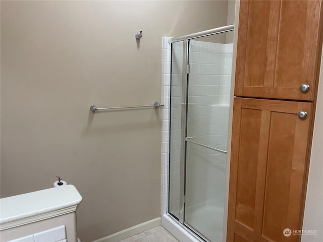 bathroom with tile patterned floors and walk in shower