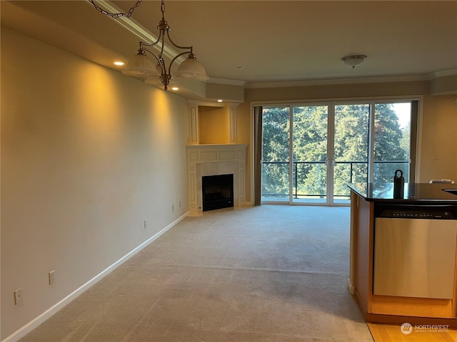 unfurnished living room featuring a notable chandelier, ornamental molding, and light colored carpet