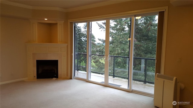 unfurnished living room with light colored carpet, plenty of natural light, and ornamental molding