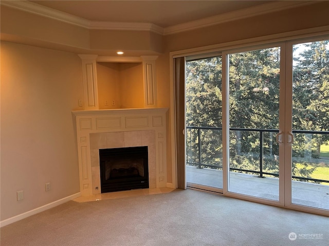 unfurnished living room with crown molding, a tile fireplace, and carpet flooring