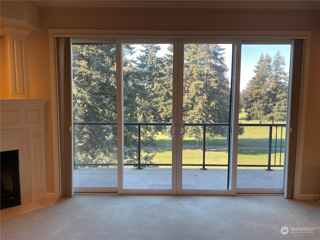 entryway featuring a fireplace and carpet flooring