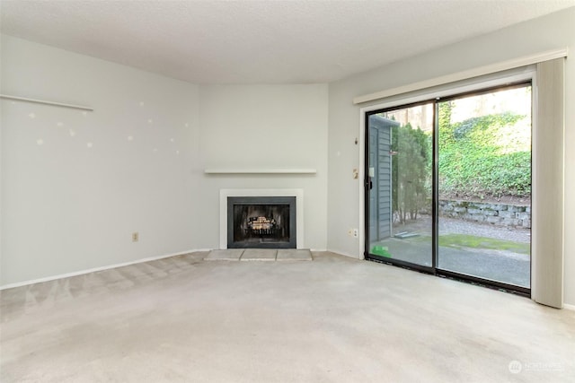 unfurnished living room featuring light carpet and a textured ceiling