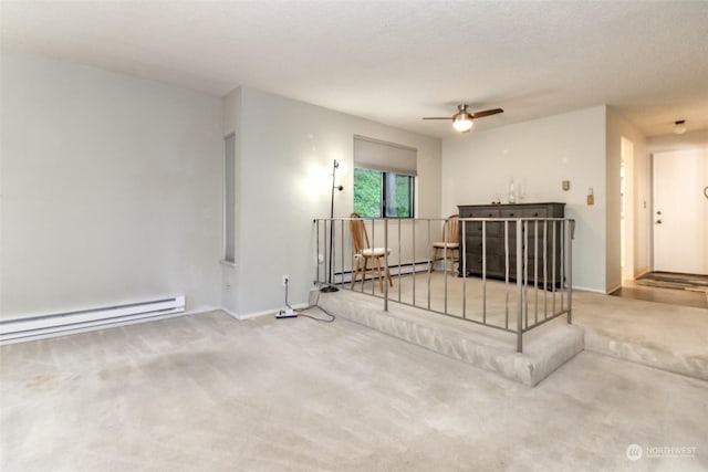 living room featuring ceiling fan, a baseboard radiator, carpet, and a textured ceiling