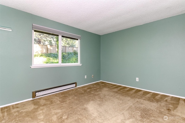 empty room with carpet, a textured ceiling, and a baseboard heating unit