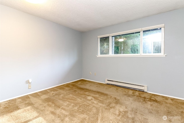 carpeted spare room with a textured ceiling and baseboard heating