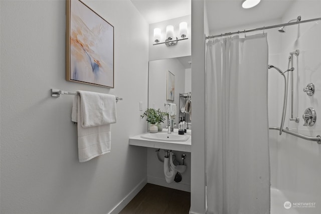 bathroom with a shower with curtain and sink