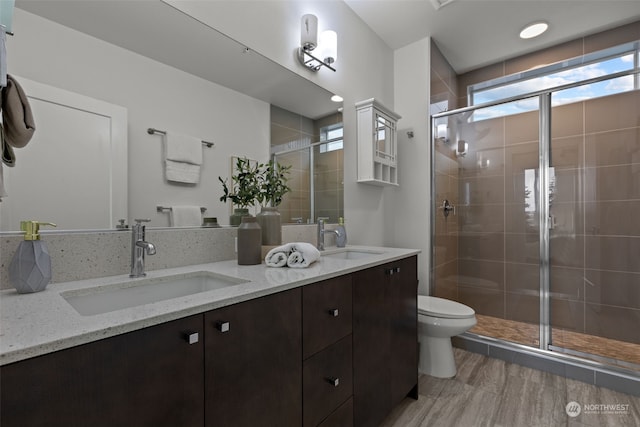 bathroom with vanity, hardwood / wood-style flooring, toilet, and walk in shower