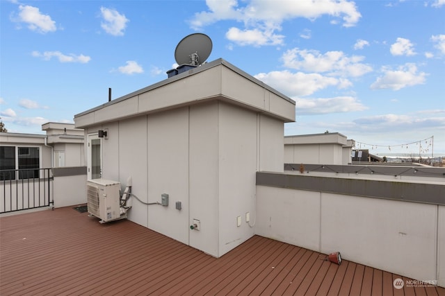 wooden terrace featuring ac unit