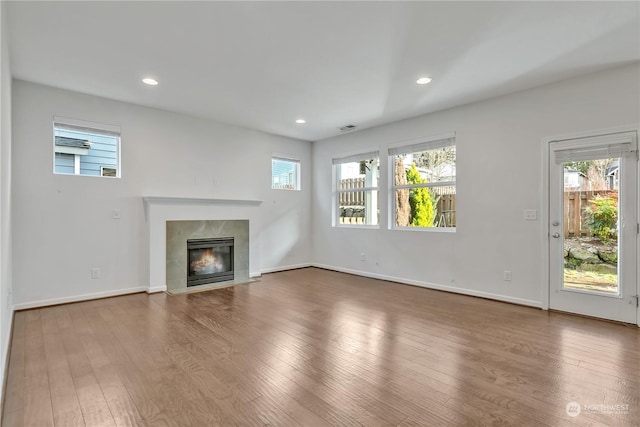 unfurnished living room with a premium fireplace and hardwood / wood-style floors