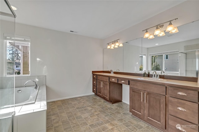 bathroom featuring vanity and independent shower and bath