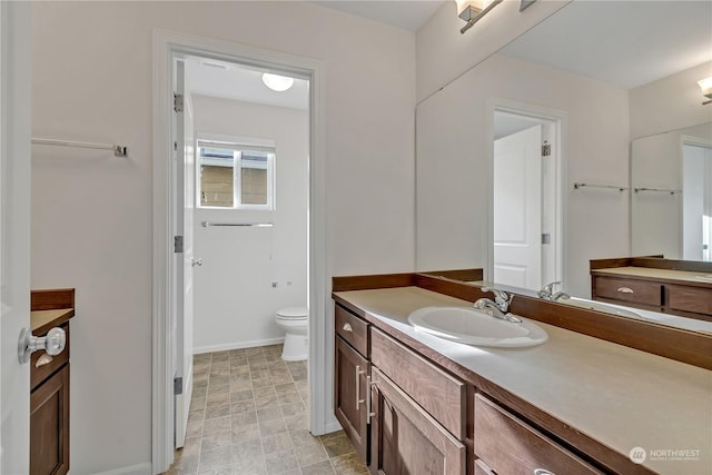 bathroom with vanity and toilet