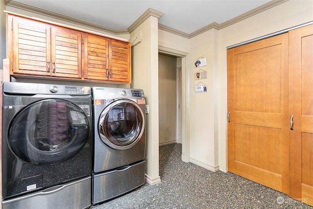 laundry area featuring ornamental molding, washing machine and dryer, and cabinets