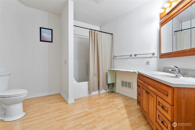 full bathroom with wood-type flooring, toilet, vanity, and shower / bath combo with shower curtain