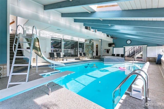 view of swimming pool with a water slide and a diving board